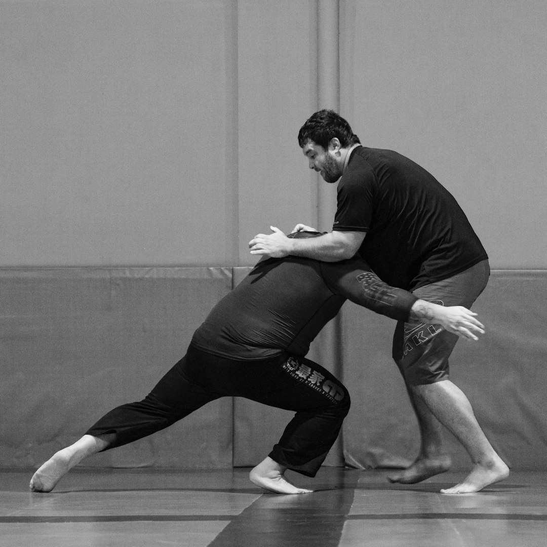 Instructor demonstrating yoga pose to student